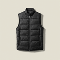 A black sleeveless puffer vest with a full-zip front, stand-up collar, and zippered hand pockets, shown flat against a light beige background.